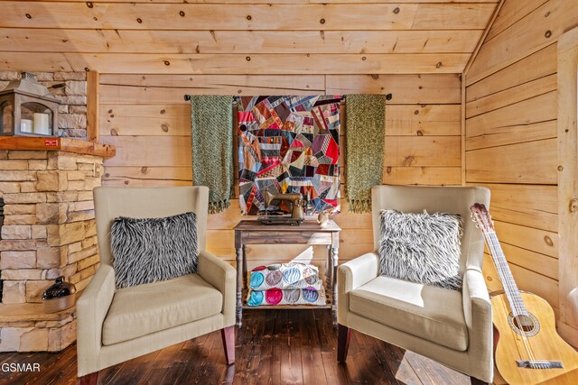 sitting room with vaulted ceiling, wood walls, wooden ceiling, and hardwood / wood-style flooring