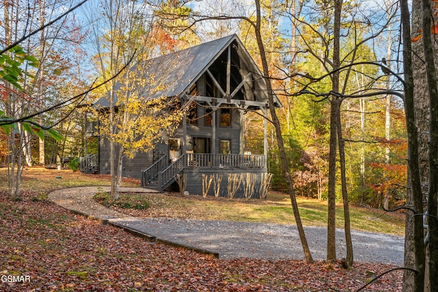 back of property featuring metal roof and stairway