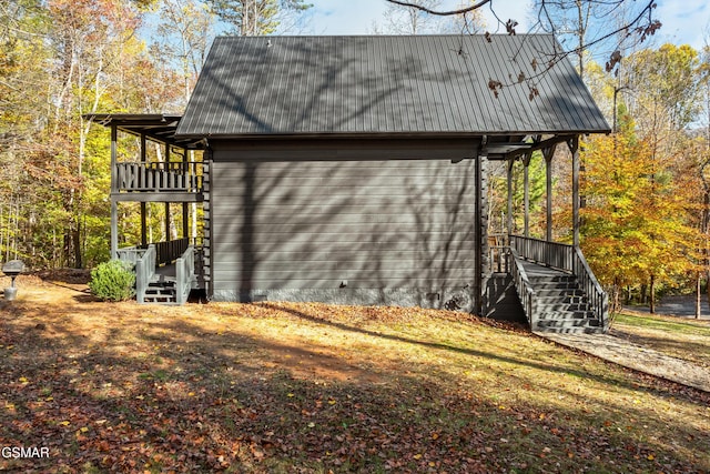 view of property exterior featuring metal roof and a balcony