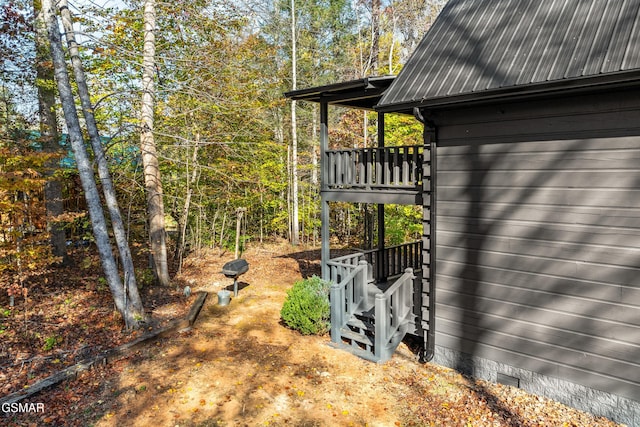 view of side of home featuring crawl space and metal roof