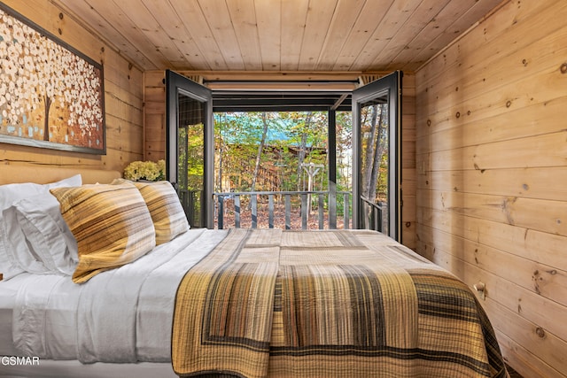 bedroom with access to outside, wood ceiling, multiple windows, and wooden walls