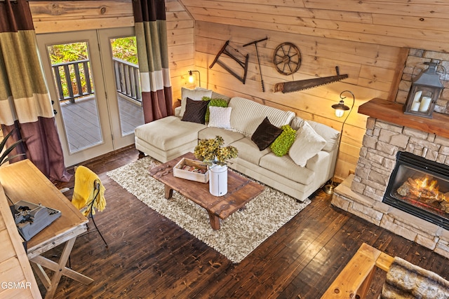 living area with hardwood / wood-style floors, a fireplace, and wooden walls