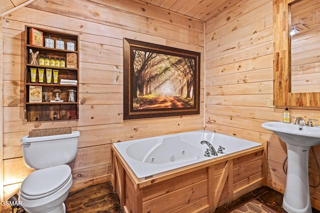 bathroom with toilet, wood walls, a tub with jets, and wood finished floors