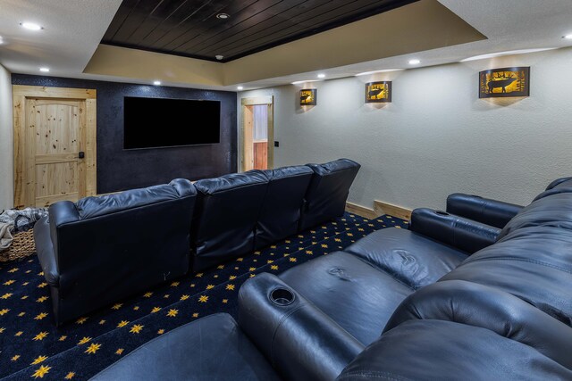 home theater room featuring a raised ceiling