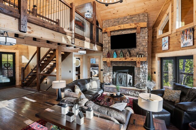 living room featuring dark hardwood / wood-style flooring, high vaulted ceiling, wooden walls, and wood ceiling