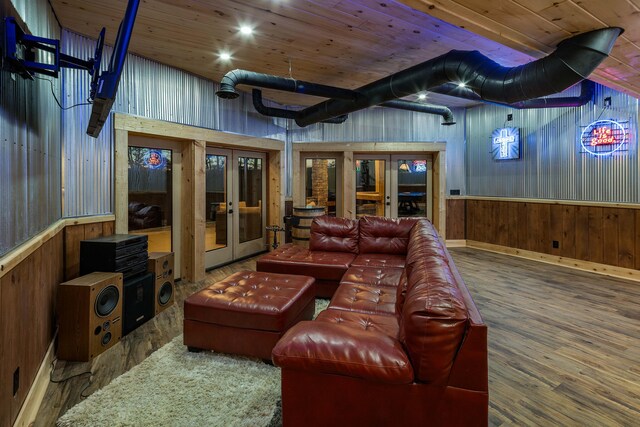 home theater room featuring hardwood / wood-style flooring, wood walls, wood ceiling, and french doors