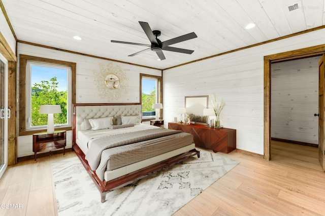 bedroom featuring ornamental molding, light wood finished floors, wooden walls, and wooden ceiling