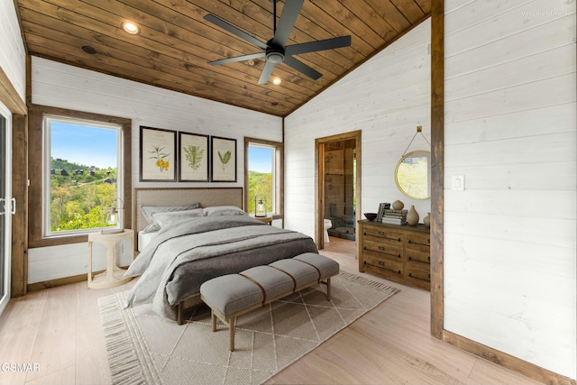 bedroom with wood ceiling, connected bathroom, wood walls, light wood-style floors, and vaulted ceiling