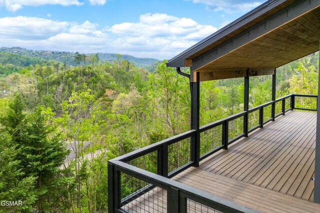 wooden deck featuring a wooded view