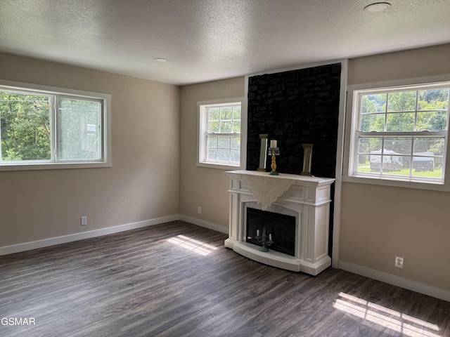 3979 Wilhite Rd, Sevierville, TN 37876 - unfurnished living room featuring a fireplace, wood finished floors, and a textured ceiling