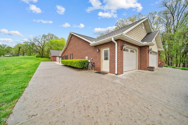225 Piney Rd, Kodak, TN 37764 - view of home's exterior with a lawn, brick siding, concrete driveway, and a garage