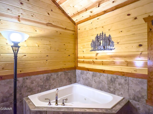 2316 Boulder Way, Sevierville, TN 37862 - bathroom featuring a bath, vaulted ceiling, and wood walls