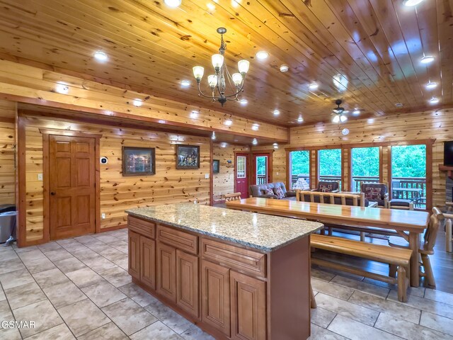 2316 Boulder Way, Sevierville, TN 37862 - kitchen featuring wooden walls, a kitchen island, recessed lighting, decorative light fixtures, and a chandelier