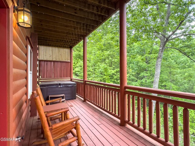 2316 Boulder Way, Sevierville, TN 37862 - wooden deck with a hot tub and a view of trees