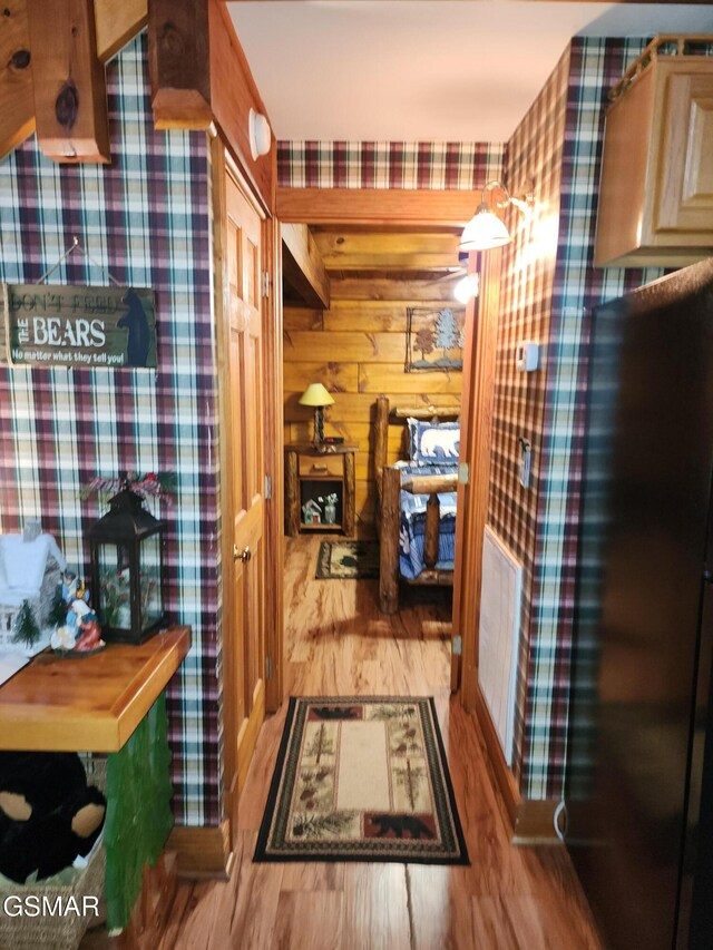 bathroom with hardwood / wood-style flooring and wood walls