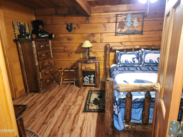 bedroom featuring hardwood / wood-style flooring, wood walls, wooden ceiling, and beamed ceiling