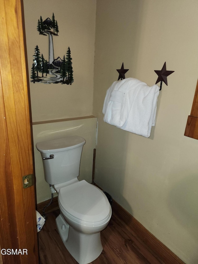 bathroom with hardwood / wood-style flooring and toilet