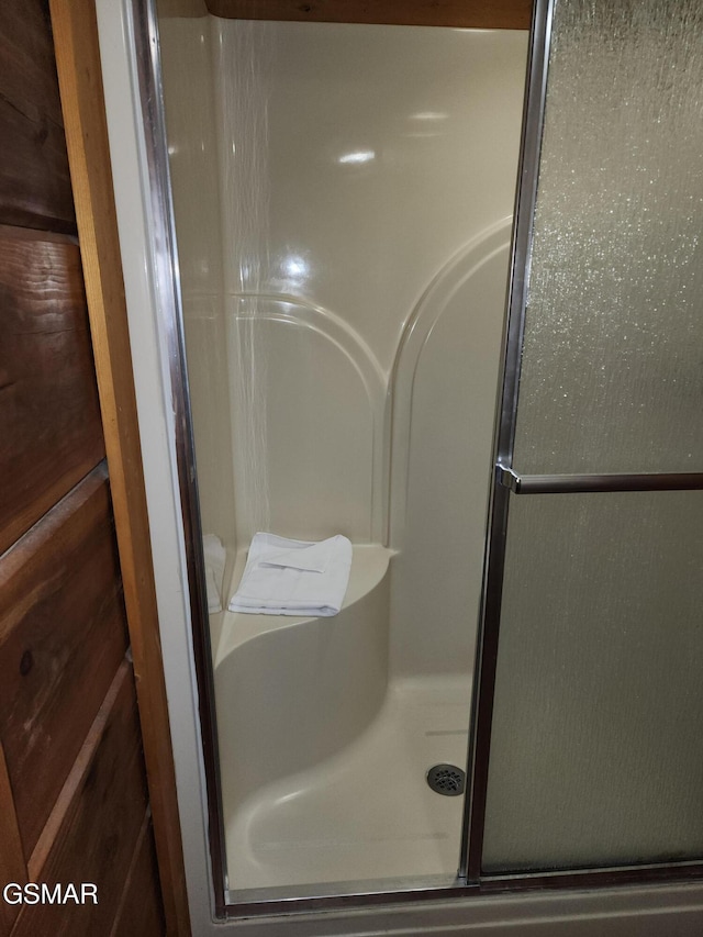 bathroom with a shower with shower door