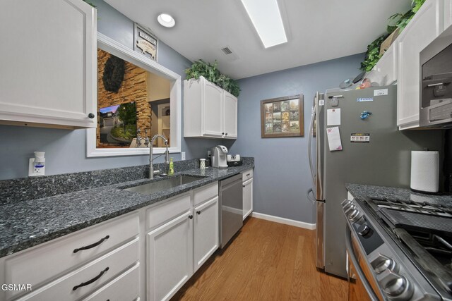 523 Apple View Way Unit 409, Sevierville, TN 37862 - kitchen featuring stainless steel appliances, light wood-style floors, white cabinets, and dark stone countertops