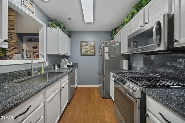 523 Apple View Way Unit 409, Sevierville, TN 37862 - kitchen with stainless steel appliances, white cabinets, light wood-style floors, and dark stone countertops