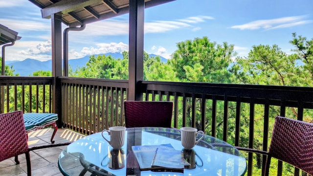 balcony featuring outdoor dining space and a mountain view
