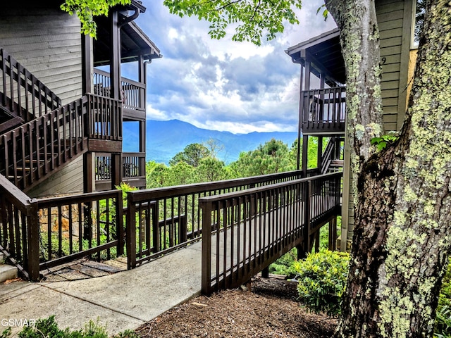 wooden deck featuring a mountain view and stairway