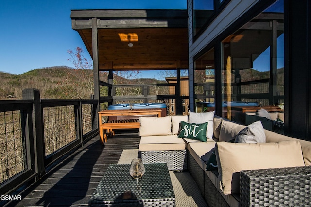 wooden deck featuring an outdoor hangout area and a mountain view