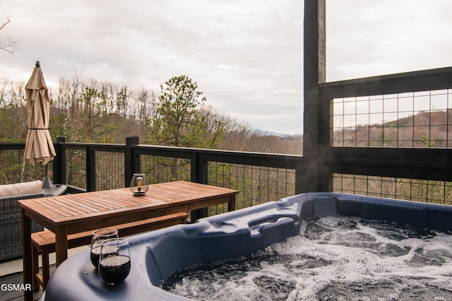 wooden terrace with a hot tub