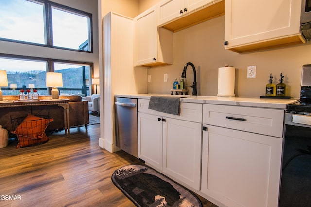 kitchen with white cabinetry, light countertops, appliances with stainless steel finishes, and light wood-style floors