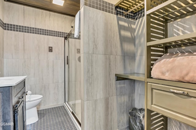 bathroom featuring tile walls, tile patterned flooring, vanity, toilet, and a shower with door