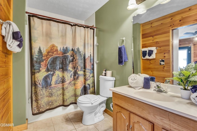 bathroom with vanity, toilet, tile patterned floors, a textured ceiling, and a shower with shower curtain