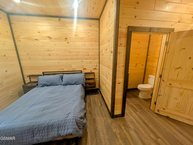 1130 Laddie Buck Ln, Gatlinburg, TN 37738 - bedroom featuring wooden walls, wood finished floors, connected bathroom, and wooden ceiling