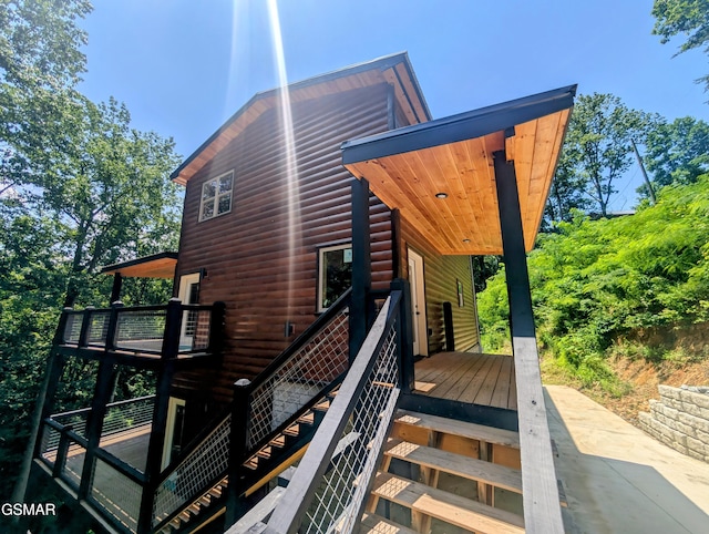 1130 Laddie Buck Ln, Gatlinburg, TN 37738 - view of home's exterior with faux log siding, a wooden deck, and stairway