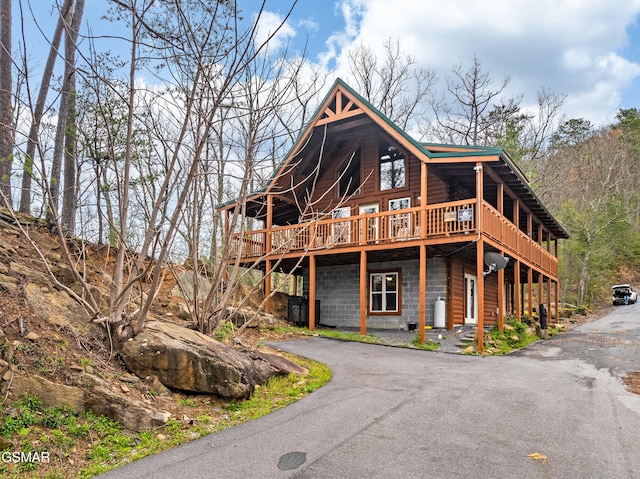 view of front of house with driveway and a deck