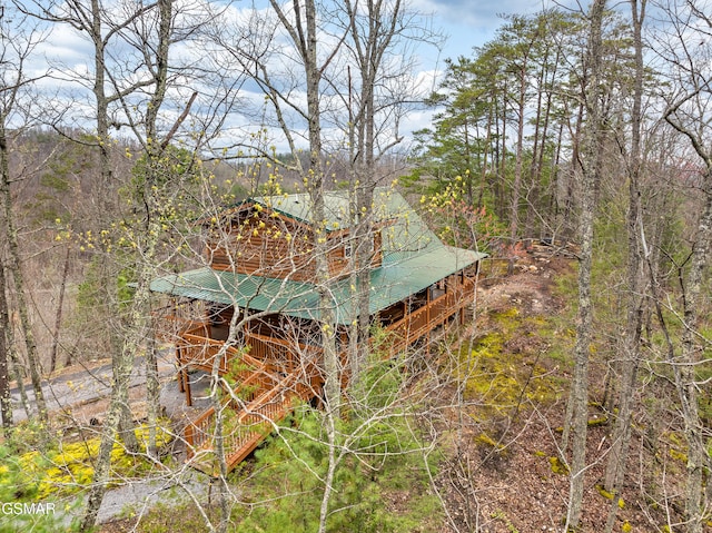 exterior space featuring a forest view