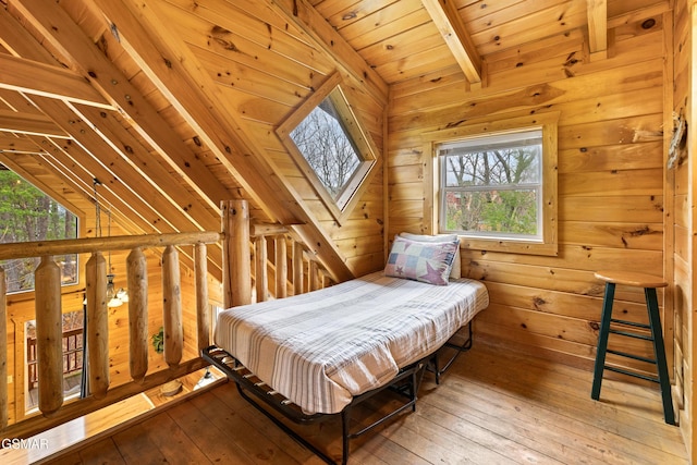 bedroom featuring vaulted ceiling with beams, wooden ceiling, light wood finished floors, and wooden walls