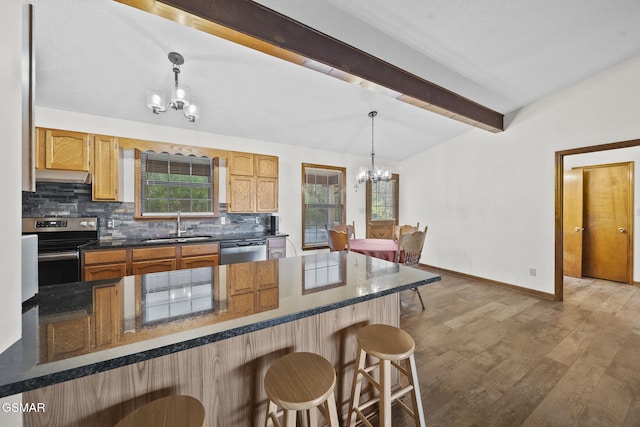 3430 Laurel Ridge Way, Sevierville, TN 37862 - kitchen with a chandelier, stainless steel appliances, under cabinet range hood, a kitchen breakfast bar, and decorative backsplash