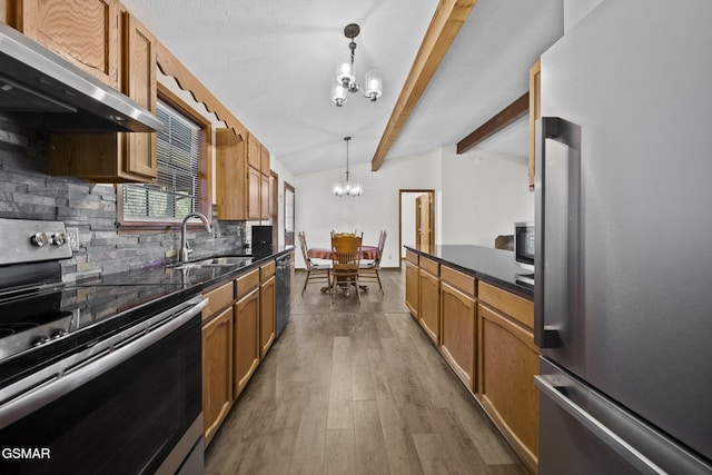 3430 Laurel Ridge Way, Sevierville, TN 37862 - kitchen with stainless steel appliances, extractor fan, a chandelier, decorative backsplash, and wood finished floors