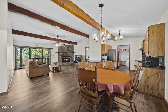 3430 Laurel Ridge Way, Sevierville, TN 37862 - dining area with a fireplace, beamed ceiling, a chandelier, ceiling fan, and dark wood-type flooring