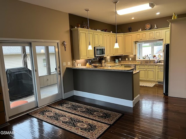 20 Brixton Ln, Crossville, TN 38555 - kitchen with a peninsula, appliances with stainless steel finishes, light stone counters, and dark wood finished floors