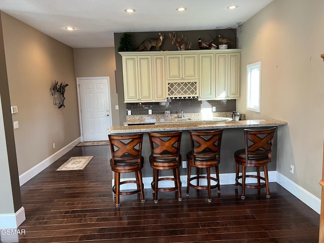 20 Brixton Ln, Crossville, TN 38555 - kitchen with tasteful backsplash, cream cabinetry, baseboards, and light stone countertops