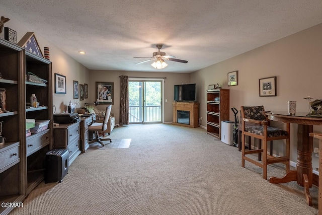20 Brixton Ln, Crossville, TN 38555 - office area with light colored carpet, a ceiling fan, a glass covered fireplace, and a textured ceiling
