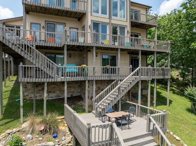 20 Brixton Ln, Crossville, TN 38555 - back of property featuring stairway, a wooden deck, and a lawn