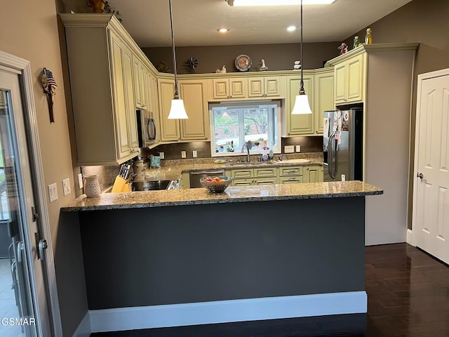 20 Brixton Ln, Crossville, TN 38555 - kitchen with light stone countertops, a peninsula, appliances with stainless steel finishes, a sink, and cream cabinets