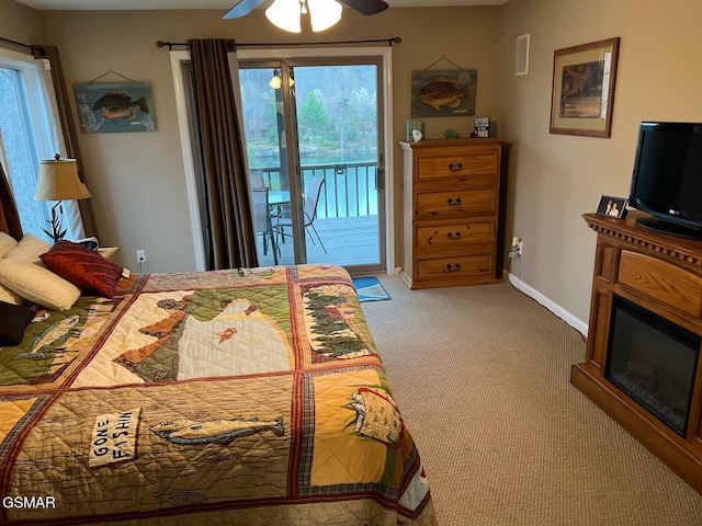 20 Brixton Ln, Crossville, TN 38555 - bedroom with a glass covered fireplace, access to outside, baseboards, ceiling fan, and light colored carpet