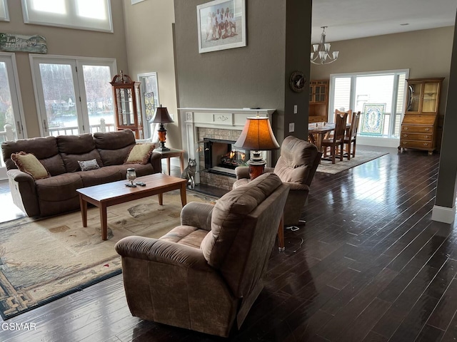 20 Brixton Ln, Crossville, TN 38555 - living area with a notable chandelier, dark wood-style flooring, a high ceiling, and a lit fireplace