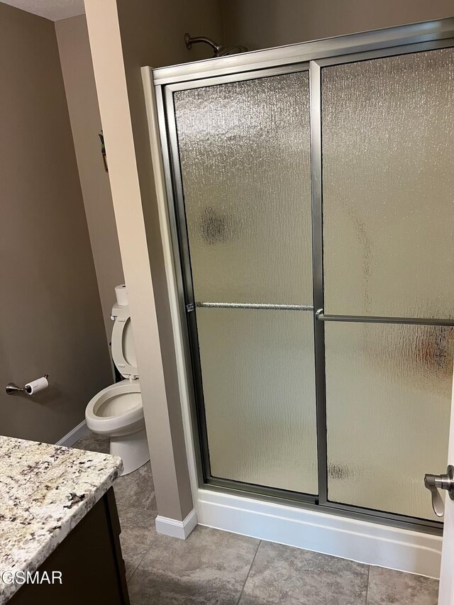 20 Brixton Ln, Crossville, TN 38555 - bathroom with a shower stall, tile patterned floors, vanity, and toilet