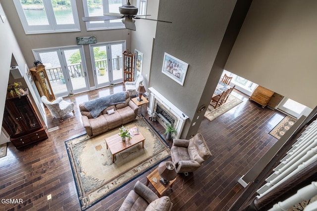 20 Brixton Ln, Crossville, TN 38555 - living area featuring a towering ceiling, wood-type flooring, a ceiling fan, french doors, and a glass covered fireplace