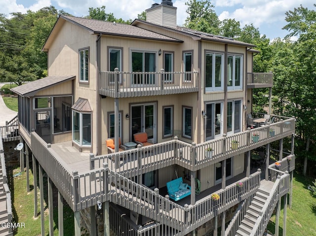 20 Brixton Ln, Crossville, TN 38555 - rear view of house with stairway, a chimney, a balcony, roof with shingles, and a sunroom