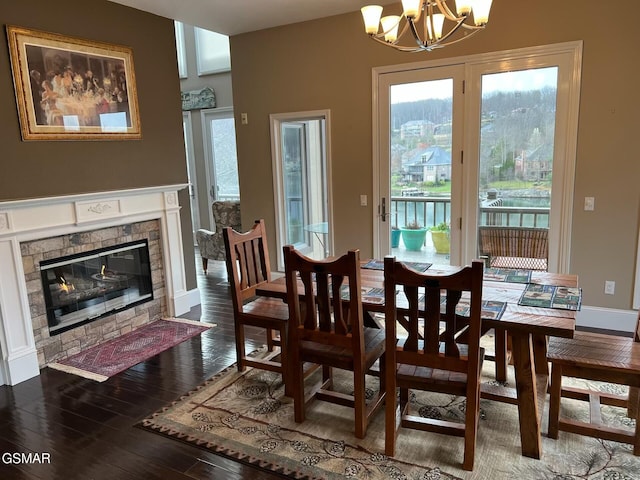 20 Brixton Ln, Crossville, TN 38555 - dining space with a chandelier, plenty of natural light, a fireplace, and dark wood finished floors